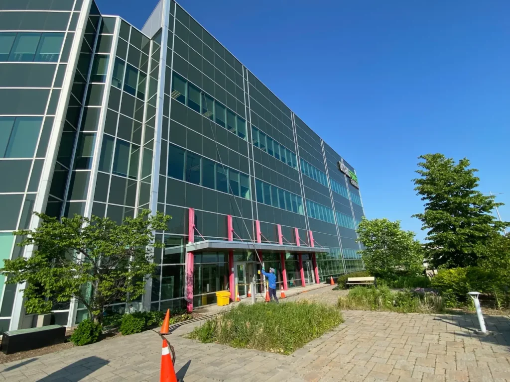 Modern corporate building with colorful accents and green landscaping.