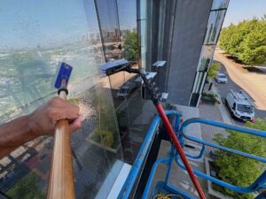 Window cleaner working from elevated platform on skyscraper