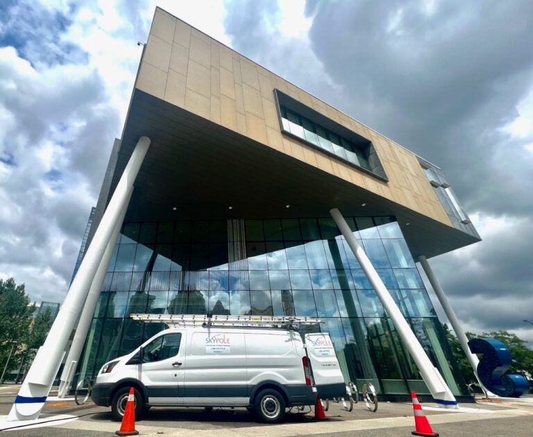 Modern building facade with white van parked in front in Mississauga