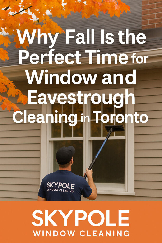 Worker cleaning house windows during autumn in Toronto