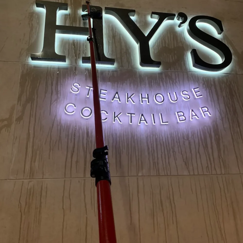 Hy's Steakhouse sign illuminated at night with cane.