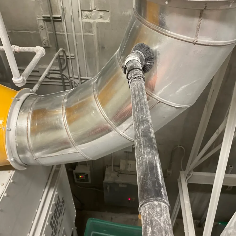 Metal ductwork in industrial setting with connecting cables.