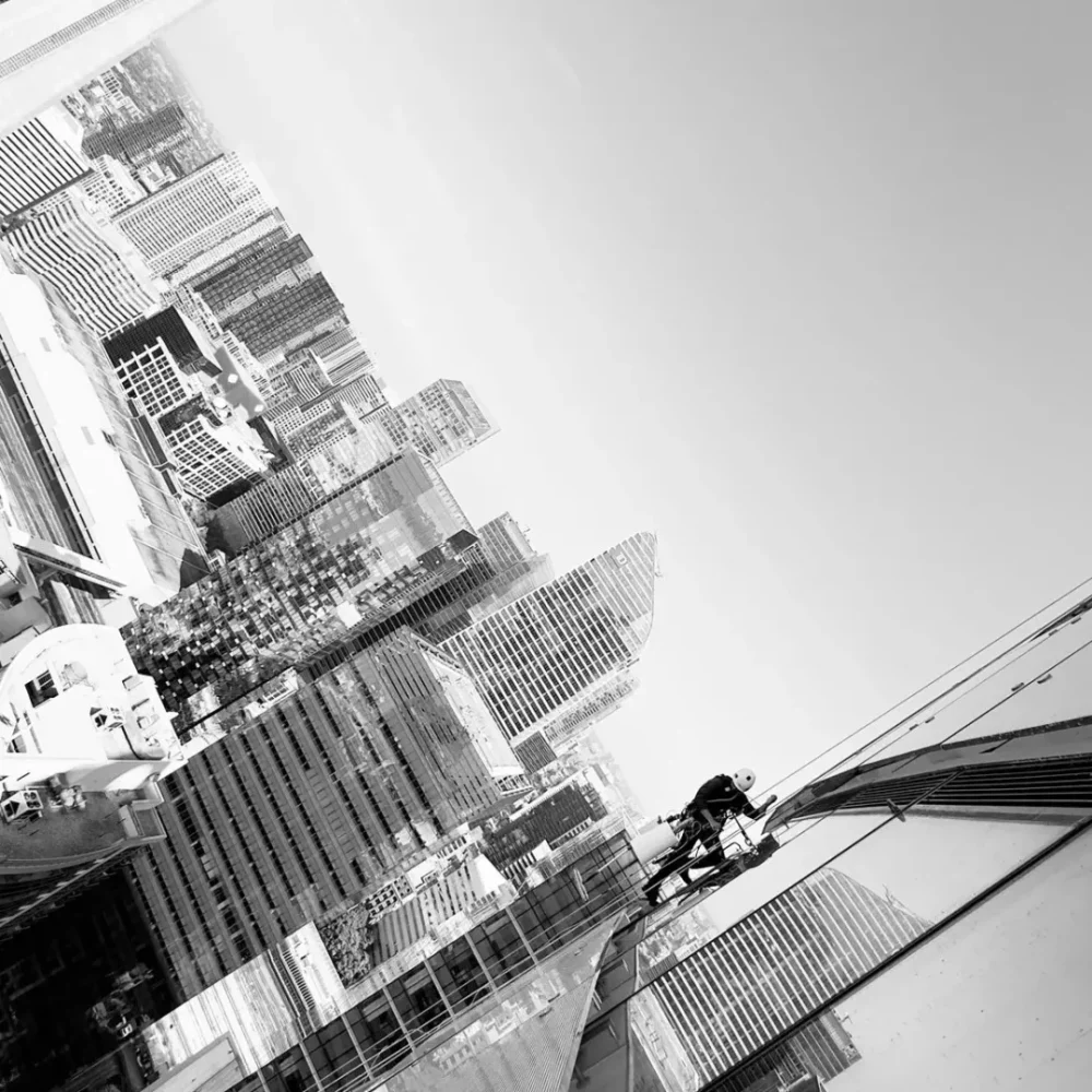 Black and white tilted cityscape with towering spire