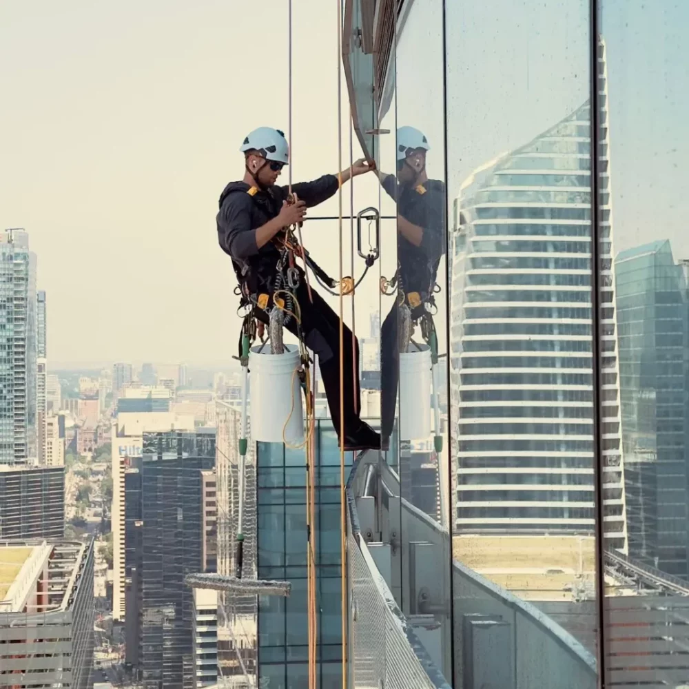Window washers working on skyscraper exterior