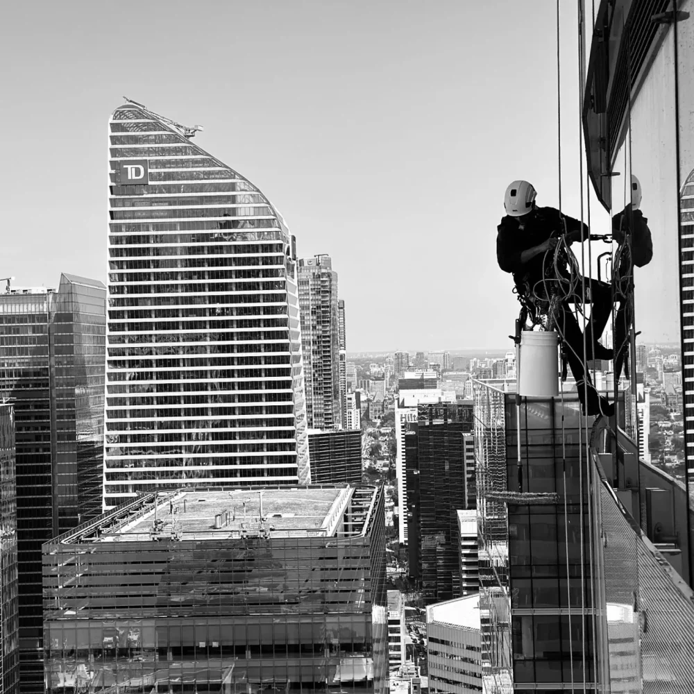 Worker rappelling on skyscraper for maintenance